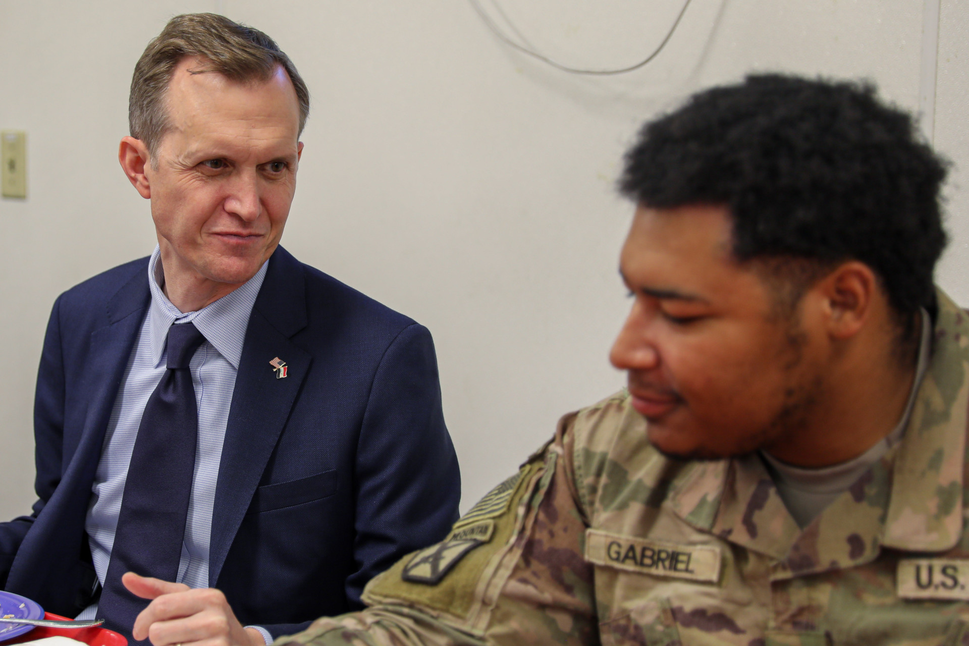Congressman George Whitesides speaks with a U.S. service member.